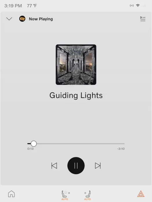 The EX30 now-playing screen showing Guiding Lights by Ghost in a light theme, with large cover art, a scrub bar and a black circular pause button.